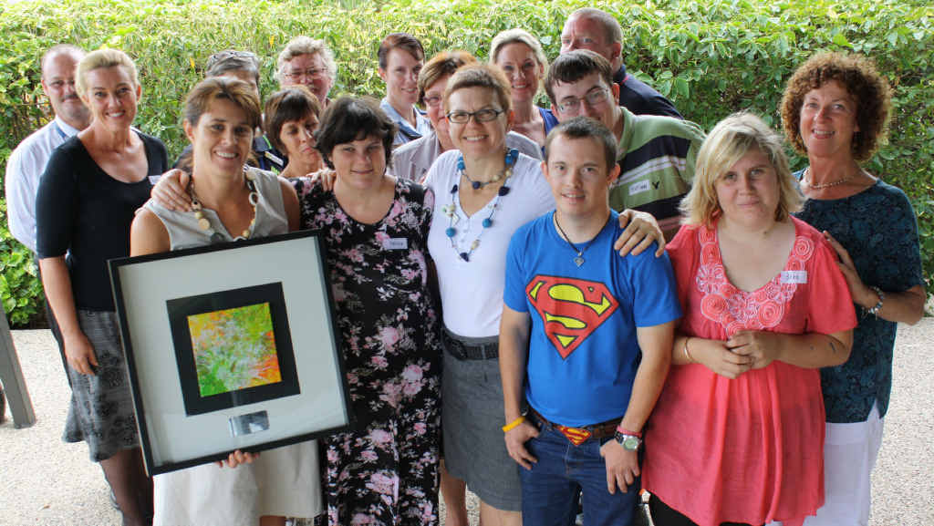 The Building Community Resilience to Natural Disaster workshop group, with Catherine Goodall from National Disability Services and (right) Emerald artist Melissa Thompson presents Goodall with an artwork. The Building Community Resilience to Natural Disaster workshop group, with Catherine Goodall from National Disability Services and (right) Emerald artist Melissa Thompson presents Goodall with an artwork.